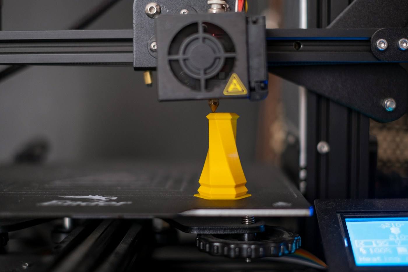 Impresora 3D con una pieza amarilla