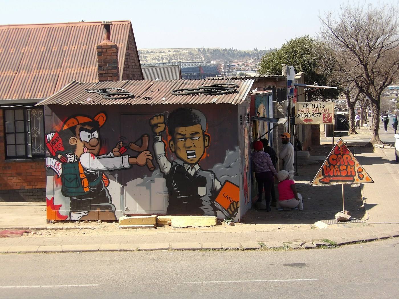 Mural en una casa de lámina en la calle